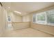 Loft area with a skylight, large windows, and neutral decor at 490 Jackson St, Denver, CO 80206