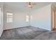 Spacious bedroom with carpet, ceiling fan, and multiple windows at 7071 Greenwater Cir, Castle Rock, CO 80108