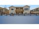 Two-story home's back exterior with deck and snowy yard at 7071 Greenwater Cir, Castle Rock, CO 80108