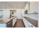 Modern kitchen with white cabinets, stainless steel appliances, and large island at 7071 Greenwater Cir, Castle Rock, CO 80108