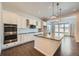 Modern kitchen with white cabinets, stainless steel appliances and an island at 7071 Greenwater Cir, Castle Rock, CO 80108