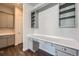 Built-in shelves and desk in an office with gray cabinets at 7071 Greenwater Cir, Castle Rock, CO 80108