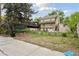 Spacious backyard with a lawn, partial fence, and view of the home's rear exterior at 1551 S University Blvd, Denver, CO 80210