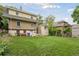 Spacious backyard featuring a lawn and rear exterior of the home at 1551 S University Blvd, Denver, CO 80210