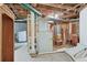 Unfinished basement featuring mechanical components and the laundry machines at 1551 S University Blvd, Denver, CO 80210