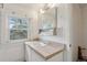 Bathroom featuring a sink and vanity with an adjacent window to let in ample natural light at 1551 S University Blvd, Denver, CO 80210