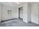 Simple bedroom featuring grey carpets, neutral walls, and a closet for ample storage at 1551 S University Blvd, Denver, CO 80210