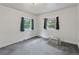 View of the bedroom featuring grey carpets and two windows that bring in ample natural light at 1551 S University Blvd, Denver, CO 80210