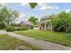 Charming two-story home featuring a well-maintained lawn and classic architectural details in a neighborhood setting at 1551 S University Blvd, Denver, CO 80210