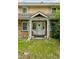 Charming front porch with dual entry doors and seating, creating an inviting entryway to the home at 1551 S University Blvd, Denver, CO 80210
