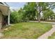 Spacious front yard with mature trees, providing a serene and shaded outdoor space at 1551 S University Blvd, Denver, CO 80210