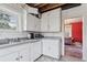 This is a kitchen ready to be remodeled, leading to living room at 1551 S University Blvd, Denver, CO 80210