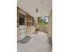 Covered porch area with a textured floor, offering a sheltered transition between indoors and outdoors at 1551 S University Blvd, Denver, CO 80210