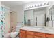 Well-lit bathroom with shower-tub combo, modern fixtures, and vanity at 643 S Norfolk Way, Aurora, CO 80017