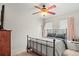 Inviting bedroom featuring ceiling fan, natural lighting, and neutral color palette at 643 S Norfolk Way, Aurora, CO 80017