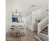 Bright and airy dining room featuring a modern table, open layout, and hardwood floors at 643 S Norfolk Way, Aurora, CO 80017