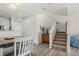 Bright living area featuring dining table, hardwood floors, and staircase at 643 S Norfolk Way, Aurora, CO 80017