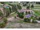 An aerial view of the property featuring the house, barn, horse riding arena, and surrounding pastures at 36700 Mossberg Ct, Elizabeth, CO 80107