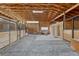 The barn features interior horse stalls, a sitting area with a couch, and exposed wood beams at 36700 Mossberg Ct, Elizabeth, CO 80107