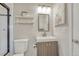 Clean bathroom featuring a sink with a mirror, a toilet, and a tiled shower at 36700 Mossberg Ct, Elizabeth, CO 80107