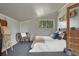 This bedroom features a cozy chair, a queen size bed, and rustic decor to add charm to the space at 36700 Mossberg Ct, Elizabeth, CO 80107