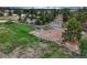 An aerial view of the horse riding arena featuring jumps surrounded by mature trees at 36700 Mossberg Ct, Elizabeth, CO 80107