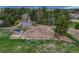 The equestrian arena features a horse riding arena with jumps surrounded by mature trees at 36700 Mossberg Ct, Elizabeth, CO 80107