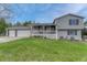 Charming two-story home with a well-manicured lawn, covered porch, and three-car garage at 36700 Mossberg Ct, Elizabeth, CO 80107
