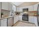 Modern kitchen with stainless steel appliances, granite countertops, and a stylish backsplash at 36700 Mossberg Ct, Elizabeth, CO 80107
