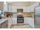 Bright kitchen featuring white cabinets, stainless steel appliances and granite counters at 36700 Mossberg Ct, Elizabeth, CO 80107