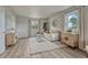 Cozy living room with wood floors, a modern rug, and plenty of natural light at 36700 Mossberg Ct, Elizabeth, CO 80107