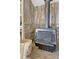 Close-up of wood burning stove featuring detailed stonework and a modern design that adds warmth and style to the room at 36700 Mossberg Ct, Elizabeth, CO 80107