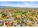 Panoramic aerial view showcasing the neighborhood with mature trees and distant mountains at 6568 S Dahlia Cir, Centennial, CO 80121