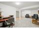 Finished basement featuring two sitting areas, laminate flooring, and neutral paint at 6568 S Dahlia Cir, Centennial, CO 80121