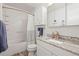 Bright bathroom featuring a shower and tub combo with an updated vanity and granite countertop at 6568 S Dahlia Cir, Centennial, CO 80121