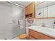 Bright bathroom with a sleek vanity, wooden cabinets and a glass door shower for a clean and modern look at 6568 S Dahlia Cir, Centennial, CO 80121