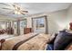 Bedroom showcasing warm colors, patterned bedding, a ceiling fan and sliding closet doors at 6568 S Dahlia Cir, Centennial, CO 80121
