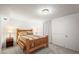 Cozy bedroom showcasing a wooden bed frame, soft carpeting, and ambient lighting for a comfortable retreat at 6568 S Dahlia Cir, Centennial, CO 80121