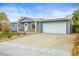 Inviting home with gray siding, a two-car garage, and solar panels on the roof at 6568 S Dahlia Cir, Centennial, CO 80121