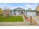 Charming home with well-maintained artificial lawn and decorative rock landscaping at 6568 S Dahlia Cir, Centennial, CO 80121