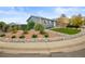 Landscaped front yard featuring decorative rock gardens, mature plants, and a well-maintained lawn at 6568 S Dahlia Cir, Centennial, CO 80121