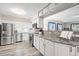Stylish kitchen with modern appliances, white cabinetry, and gray marble countertops at 6568 S Dahlia Cir, Centennial, CO 80121