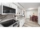 Gourmet kitchen with modern appliances, marble counters, and an open layout to the dining area at 6568 S Dahlia Cir, Centennial, CO 80121