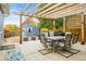 Inviting backyard patio featuring a pergola, dining table, grill, and a shed in a tranquil outdoor setting at 6568 S Dahlia Cir, Centennial, CO 80121