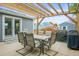 Outdoor patio featuring a pergola, dining set, and a grill, perfect for entertaining guests at 6568 S Dahlia Cir, Centennial, CO 80121