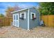 Backyard shed with white trim, double doors and flower boxes at 6568 S Dahlia Cir, Centennial, CO 80121