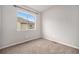 A serene bedroom with plush carpeting, neutral walls, and a window offering natural light at 11250 Florence St # 29D, Commerce City, CO 80640