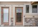 Close-up of the front door and entrance with stone accent and painted trim detail at 11250 Florence St # 29D, Commerce City, CO 80640