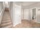 Hallway with staircase, tile flooring, and white doors leading to various rooms in the house at 11250 Florence St # 29D, Commerce City, CO 80640
