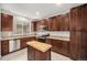 A well-appointed kitchen with stainless appliances, an island with butcher block, and dark wood cabinetry at 11250 Florence St # 29D, Commerce City, CO 80640